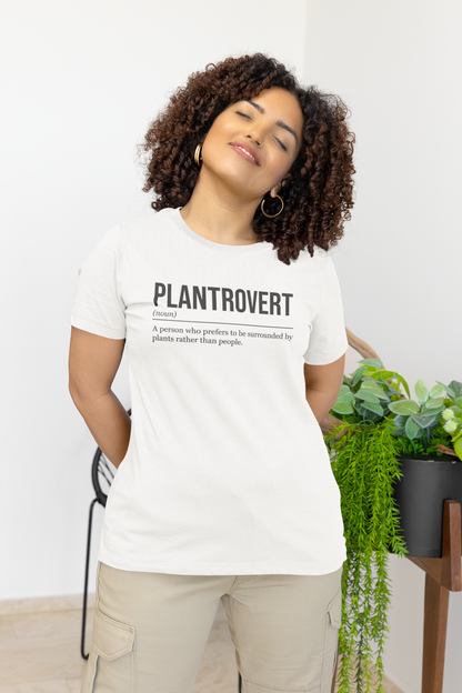 A standing woman with closed eyes and her arms behind her, front view, wearing a white plant T-shirt showing the definition of the word Plantrovert.