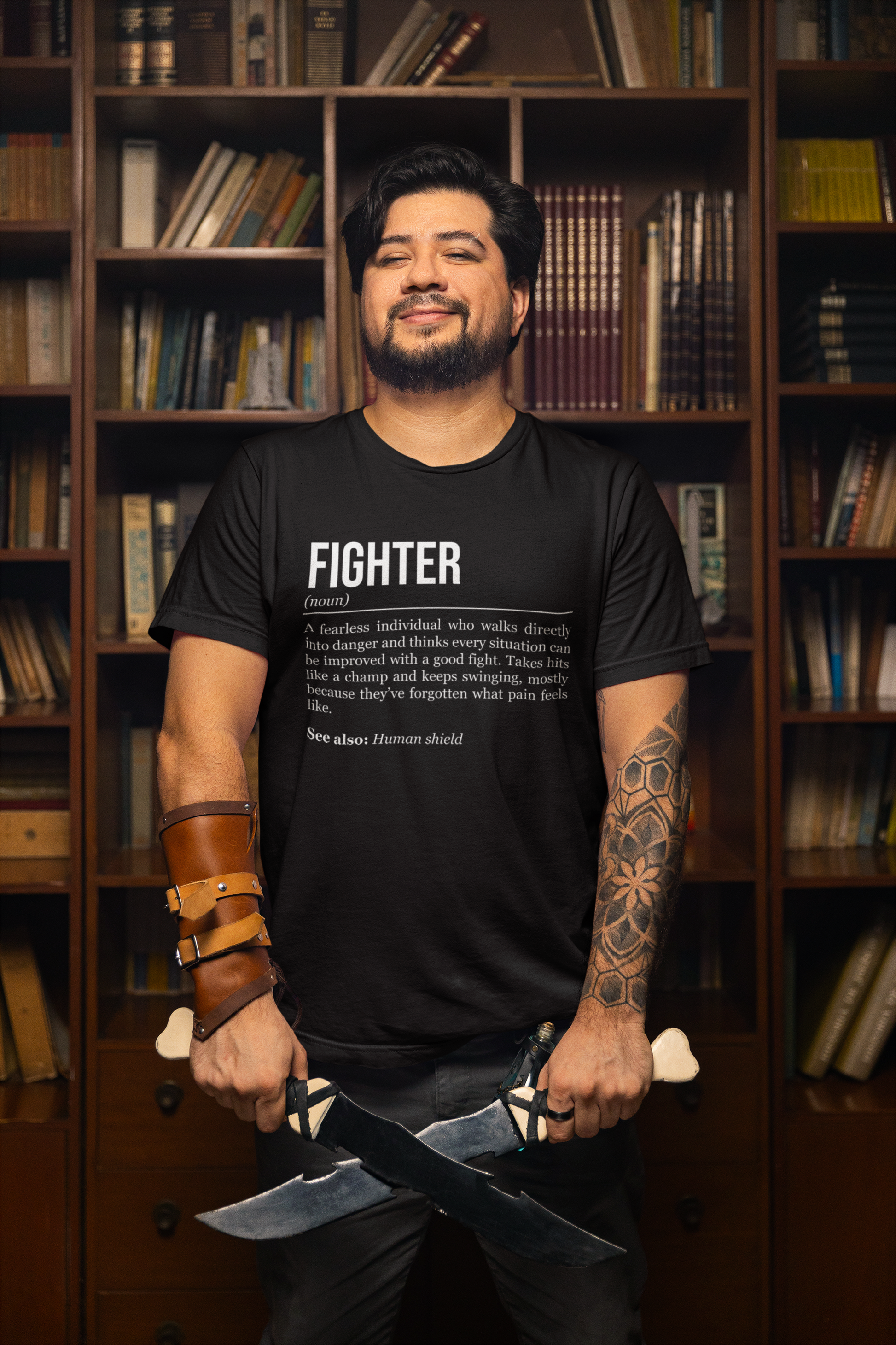 A standing man holding two short swords, wearing a black fighter T-shirt showing the definition of the class Fighter.