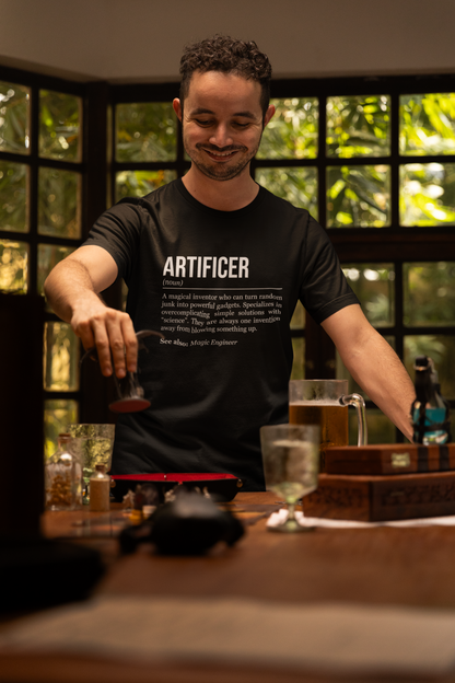 A standing man playing an RPG at a table, wearing a black artificer T-shirt showing the definition of the class Artificer. 